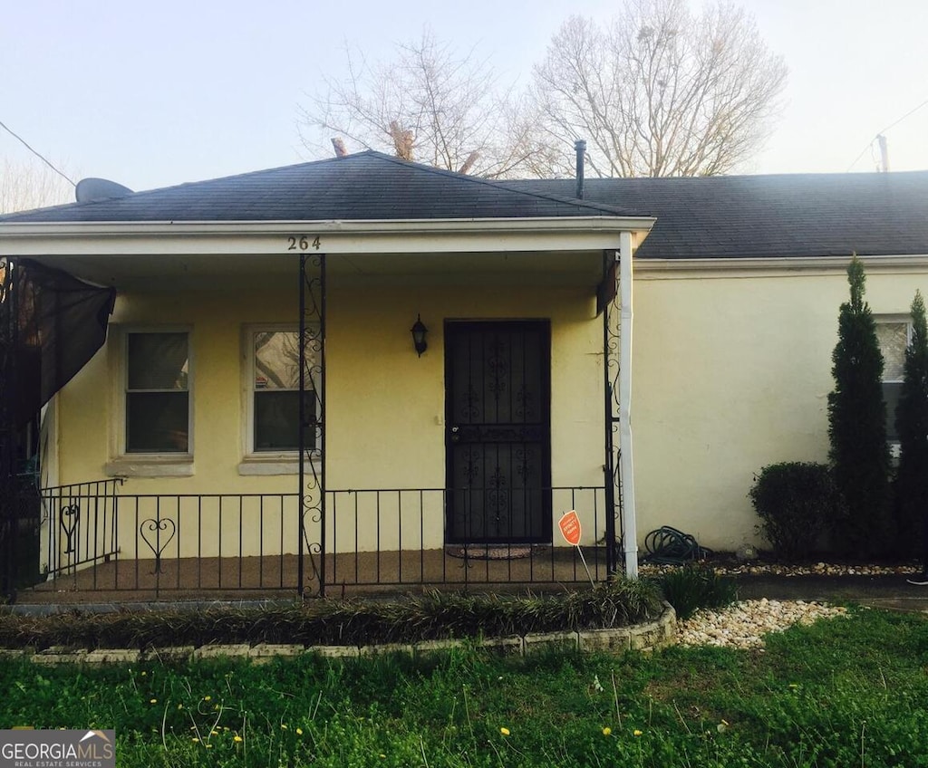264 Taft St SW, Atlanta, GA 30315 - view of front of property with stucco siding, roof with shingles, and covered porch