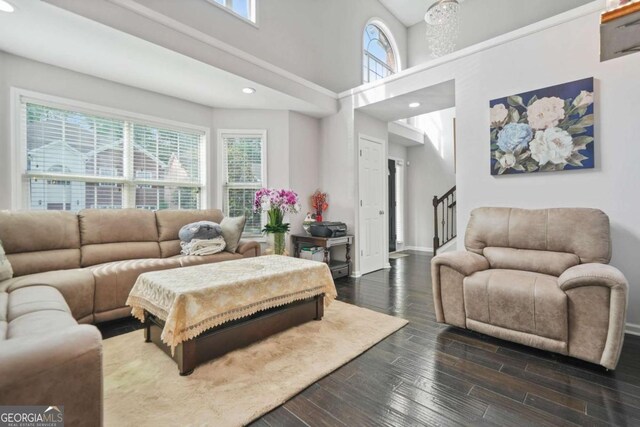 4125 Fallbrook Dr, Duluth, GA 30096 - living area with dark wood finished floors, baseboards, a towering ceiling, stairs, and recessed lighting