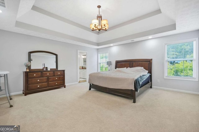 4125 Fallbrook Dr, Duluth, GA 30096 - carpeted bedroom with a raised ceiling, a chandelier, baseboards, recessed lighting, and ensuite bath