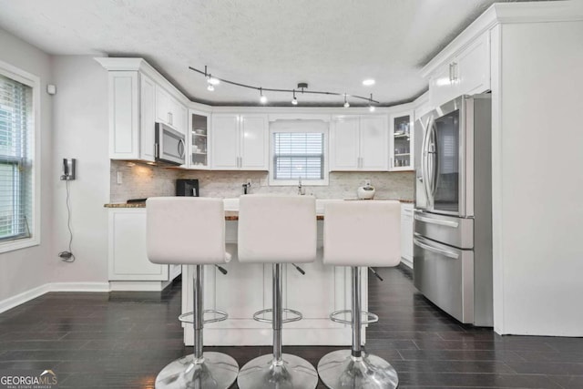 4125 Fallbrook Dr, Duluth, GA 30096 - kitchen featuring stainless steel appliances, tasteful backsplash, and white cabinetry