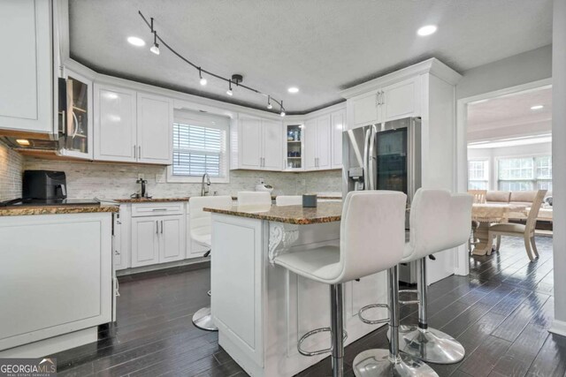 4125 Fallbrook Dr, Duluth, GA 30096 - kitchen with dark wood-type flooring, white cabinets, tasteful backsplash, and recessed lighting