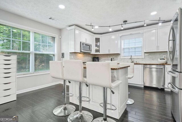 4125 Fallbrook Dr, Duluth, GA 30096 - kitchen featuring appliances with stainless steel finishes, white cabinets, backsplash, recessed lighting, and a textured ceiling