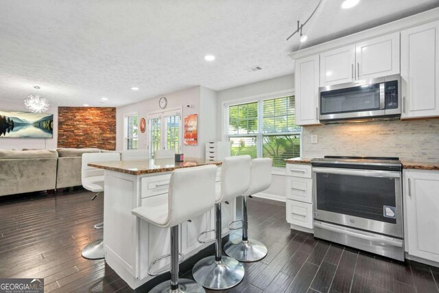 4125 Fallbrook Dr, Duluth, GA 30096 - kitchen featuring stainless steel appliances, recessed lighting, dark wood-style flooring, white cabinetry, and a textured ceiling