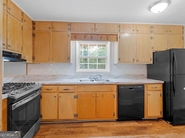 2609 Lake Harbin Rd, Morrow, GA 30260 - kitchen with black appliances, under cabinet range hood, a sink, light wood-style floors, and light countertops