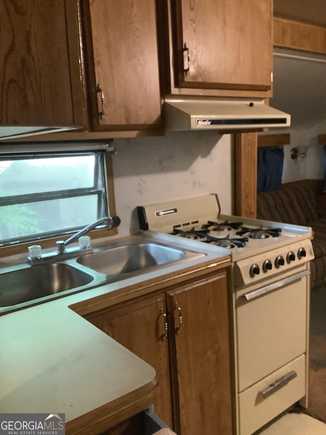 961 Mountain Shadows Dr, Cleveland, GA 30528 - kitchen with white range with gas cooktop, range hood, a sink, and light countertops