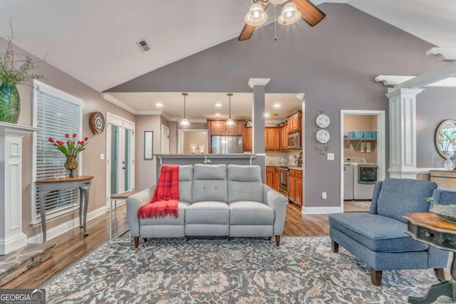 living room featuring washer / dryer, a ceiling fan, decorative columns, light wood finished floors, and recessed lighting