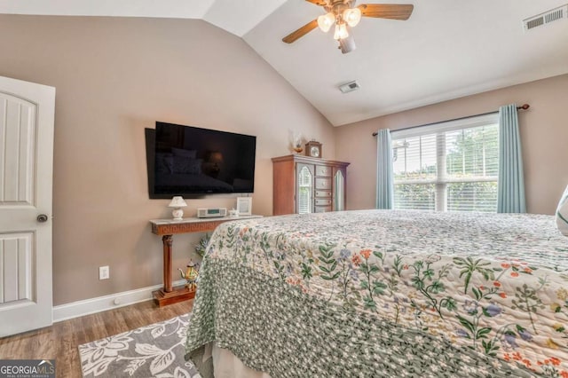 bedroom with wood finished floors, vaulted ceiling, baseboards, and a ceiling fan