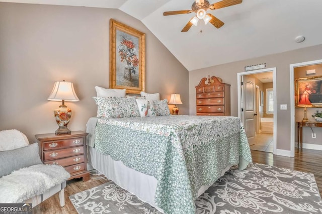 bedroom with wood finished floors, lofted ceiling, baseboards, and ceiling fan