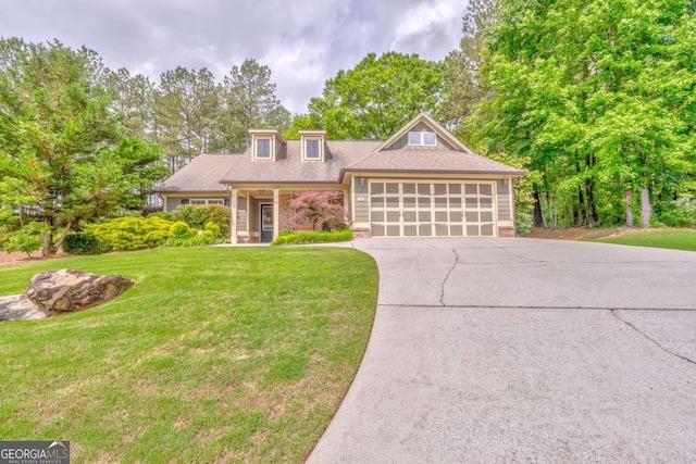 view of front of home featuring a garage, concrete driveway, and a front yard