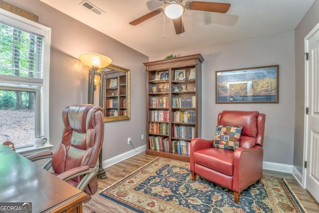 office space featuring wood finished floors, plenty of natural light, and baseboards