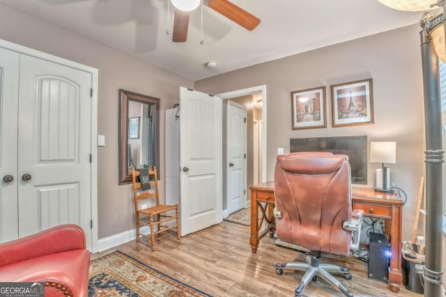 office space with ceiling fan, wood finished floors, and baseboards