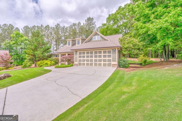 view of front of house with concrete driveway, a front yard, an attached garage, and roof with shingles