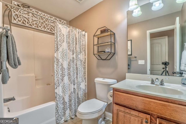 bathroom featuring toilet, vanity, shower / bath combo with shower curtain, and tile patterned flooring