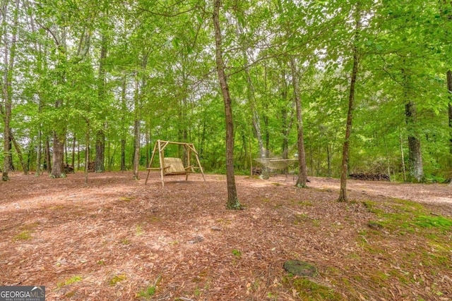 view of yard with a view of trees