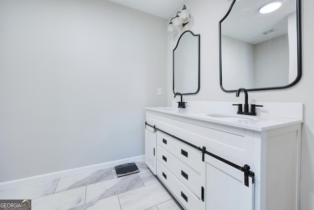 132 Jefferson Dr, Columbus, GA 31907 - full bath with baseboards, double vanity, and marble look tiles