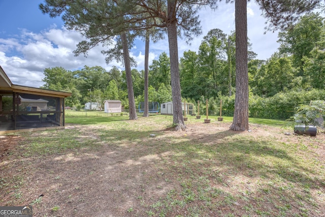 132 Jefferson Dr, Columbus, GA 31907 - view of yard featuring a storage shed, an outdoor structure, and a sunroom