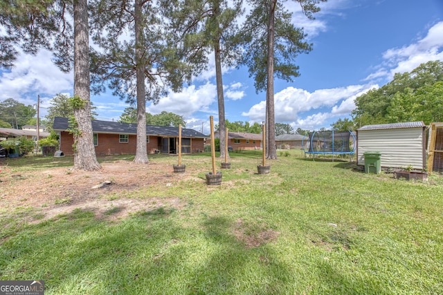 132 Jefferson Dr, Columbus, GA 31907 - view of green lawn with a trampoline