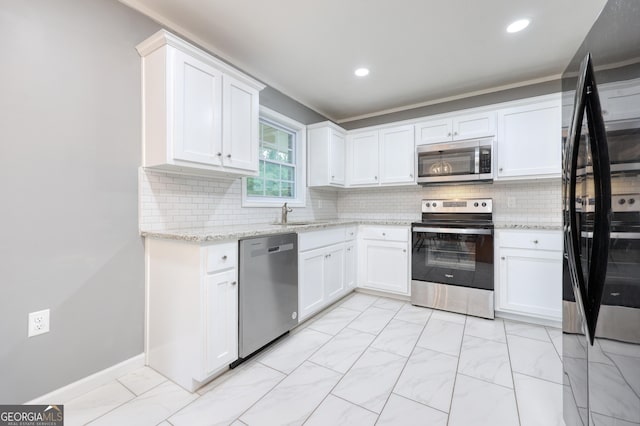 132 Jefferson Dr, Columbus, GA 31907 - kitchen featuring appliances with stainless steel finishes, white cabinetry, decorative backsplash, light stone countertops, and recessed lighting