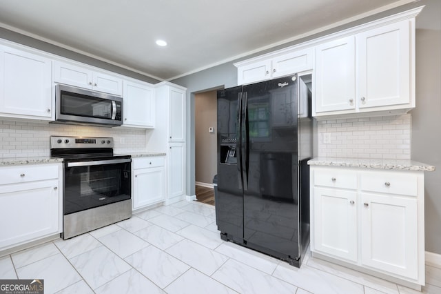 132 Jefferson Dr, Columbus, GA 31907 - kitchen with stainless steel appliances, white cabinets, decorative backsplash, and recessed lighting