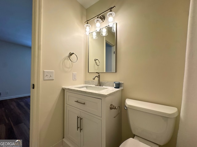 3340 Zingara Rd, Conyers, GA 30012 - half bath with toilet, vanity, baseboards, and wood finished floors