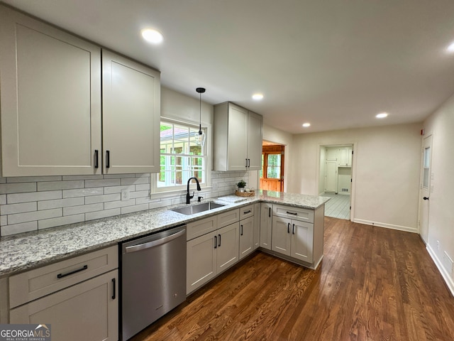 3340 Zingara Rd, Conyers, GA 30012 - kitchen with dishwasher, a sink, a peninsula, dark wood-style flooring, and decorative backsplash