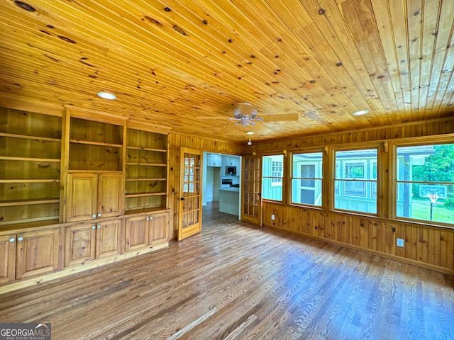 3340 Zingara Rd, Conyers, GA 30012 - unfurnished living room with wooden ceiling, wooden walls, wood finished floors, and a ceiling fan