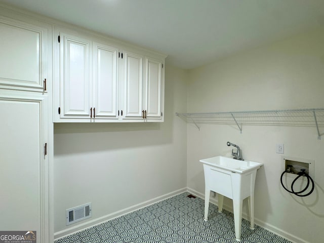 3340 Zingara Rd, Conyers, GA 30012 - washroom featuring washer hookup, cabinet space, and baseboards