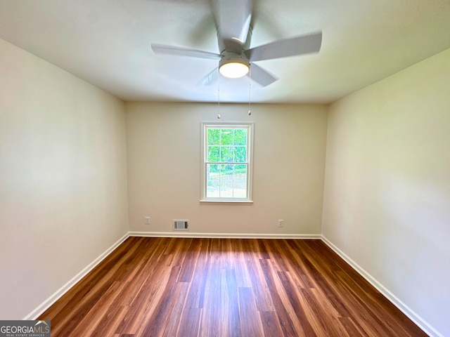 3340 Zingara Rd, Conyers, GA 30012 - spare room featuring dark wood-style floors, a ceiling fan, and baseboards