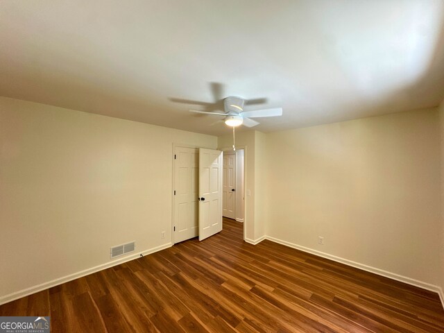 3340 Zingara Rd, Conyers, GA 30012 - spare room featuring baseboards, a ceiling fan, and dark wood-style floors