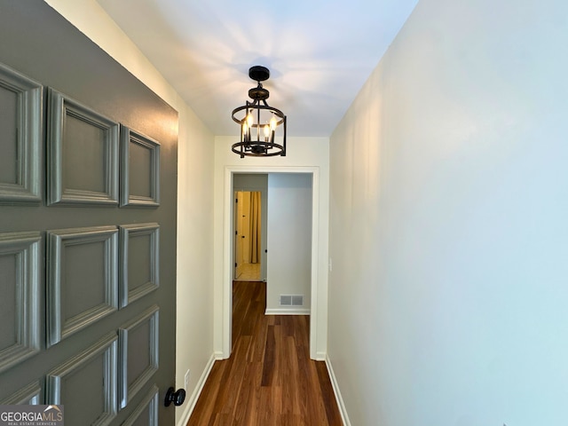 3340 Zingara Rd, Conyers, GA 30012 - hallway featuring a chandelier, baseboards, and dark wood-type flooring