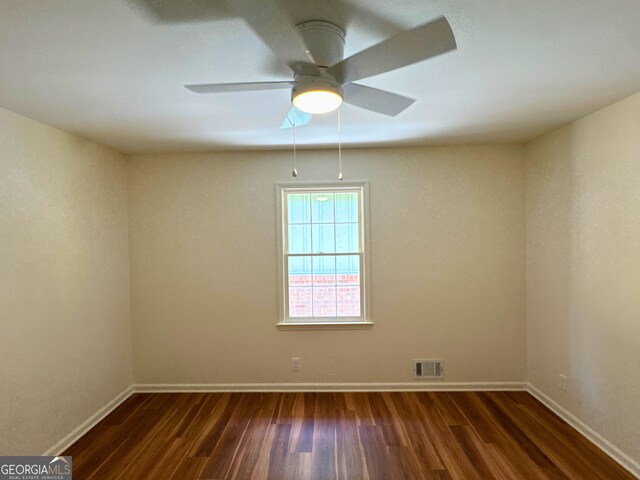 3340 Zingara Rd, Conyers, GA 30012 - empty room featuring dark wood-type flooring, baseboards, and ceiling fan