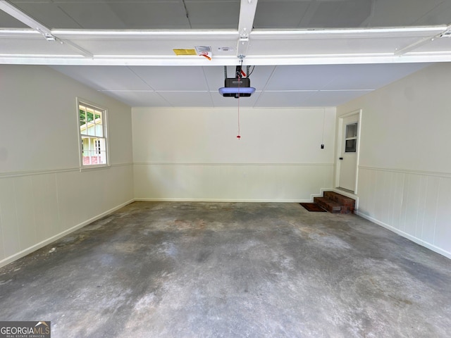 3340 Zingara Rd, Conyers, GA 30012 - garage featuring a garage door opener and wainscoting