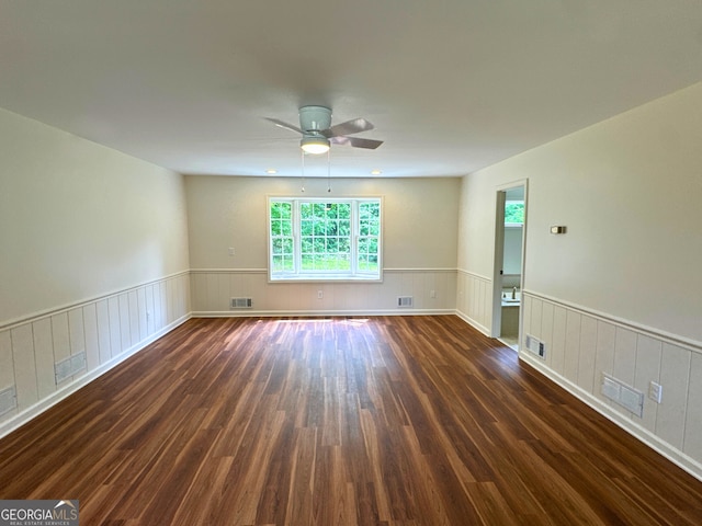 3340 Zingara Rd, Conyers, GA 30012 - empty room featuring wood finished floors, a wainscoted wall, and ceiling fan
