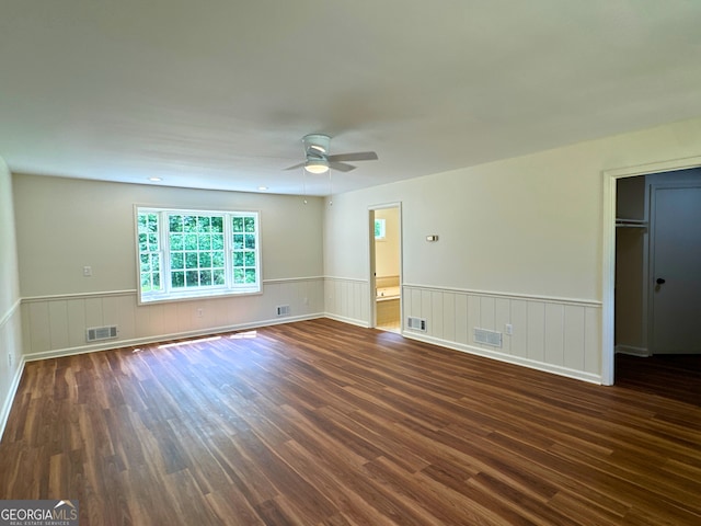 3340 Zingara Rd, Conyers, GA 30012 - spare room featuring dark wood-type flooring, a ceiling fan, and a wainscoted wall