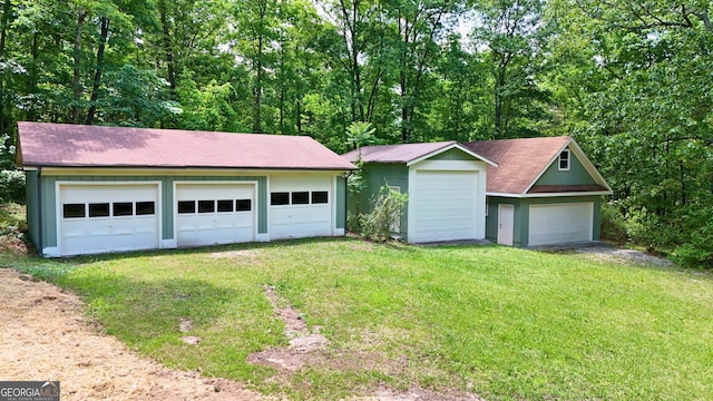 3340 Zingara Rd, Conyers, GA 30012 - view of front of home with an outbuilding, a shingled roof, and a detached garage