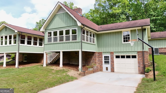 3340 Zingara Rd, Conyers, GA 30012 - back of house with an attached garage, a chimney, roof with shingles, driveway, and central AC unit