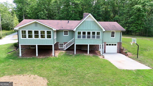 3340 Zingara Rd, Conyers, GA 30012 - rear view of property featuring concrete driveway, a garage, a chimney, a yard, and stairs