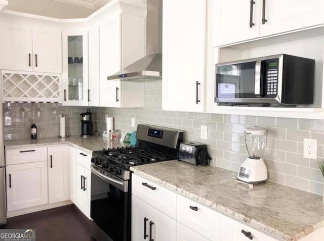 2132 Memorial Dr SE, Atlanta, GA 30317 - kitchen with appliances with stainless steel finishes, wall chimney exhaust hood, and white cabinets