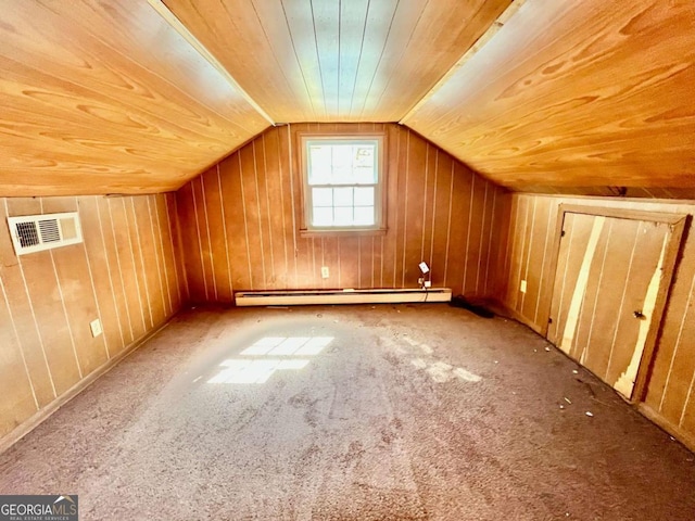 additional living space featuring a baseboard heating unit, lofted ceiling, wood walls, and carpet floors