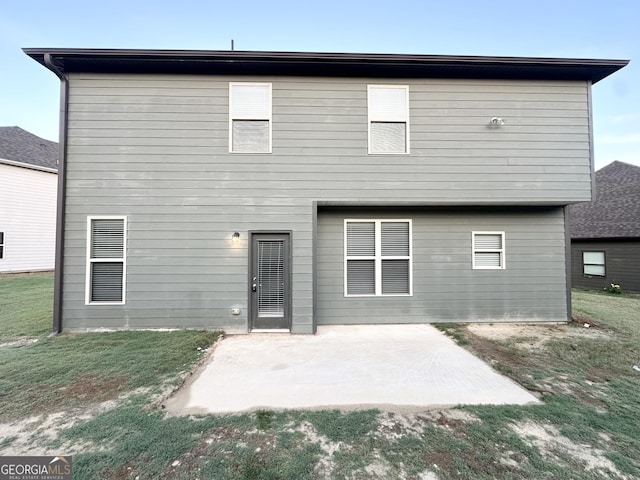rear view of property with a patio and a yard