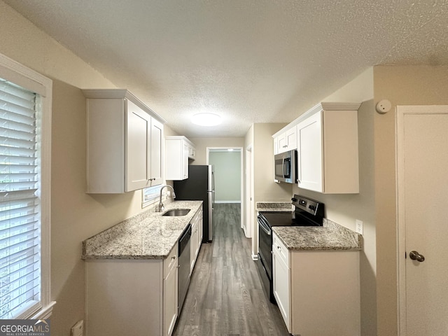 5219 Maple Valley Rd SW, Mableton, GA 30126 - kitchen featuring appliances with stainless steel finishes, a sink, a textured ceiling, wood finished floors, and white cabinetry