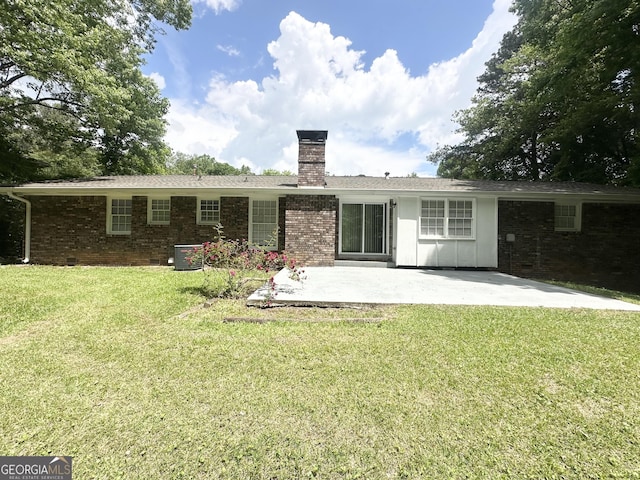 4313 Executive Dr, Stone Mountain, GA 30083 - rear view of property featuring a patio area, a chimney, a lawn, brick siding, and central AC