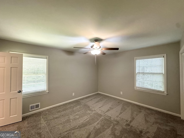 4313 Executive Dr, Stone Mountain, GA 30083 - unfurnished room featuring ceiling fan, carpet floors, healthy amount of natural light, and baseboards