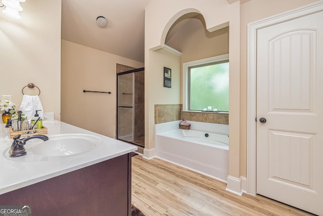 139 Village Park Dr, Newnan, GA 30265 - bathroom with a stall shower, a bath, wood finished floors, and double vanity