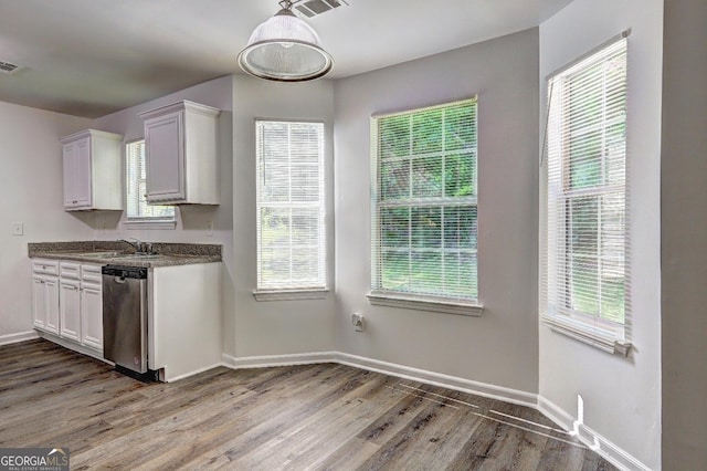 kitchen with dishwasher, wood finished floors, and baseboards