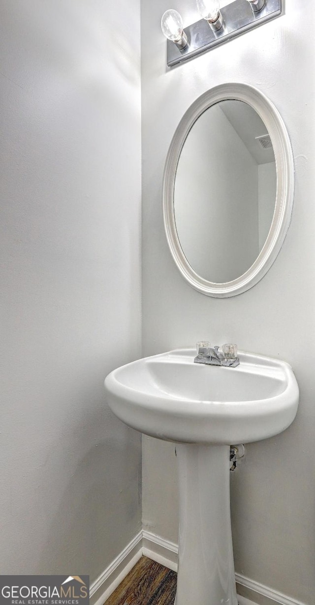 bathroom with baseboards and a sink