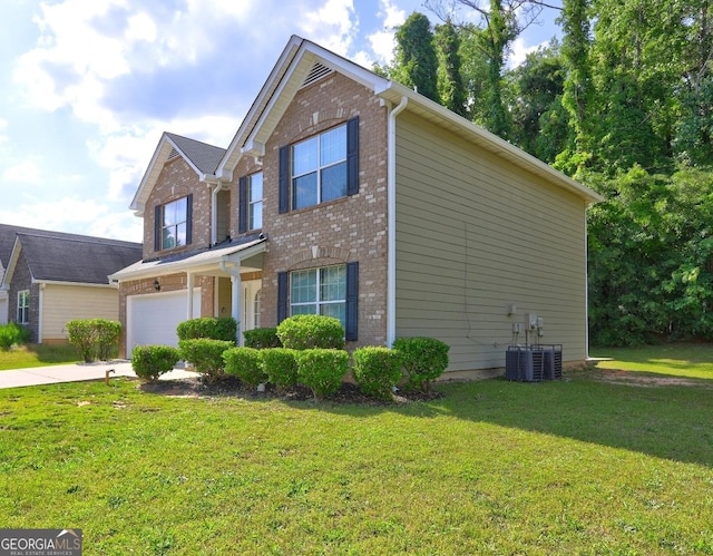 traditional-style home with brick siding, a garage, driveway, a front yard, and central AC