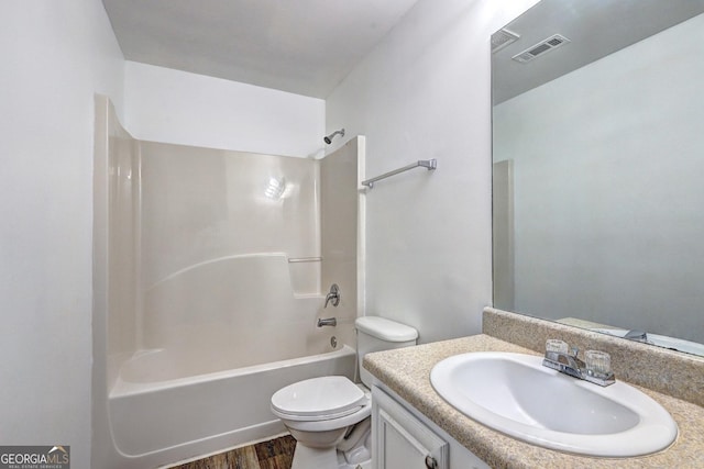 bathroom featuring toilet, vanity, shower / bath combination, and wood finished floors
