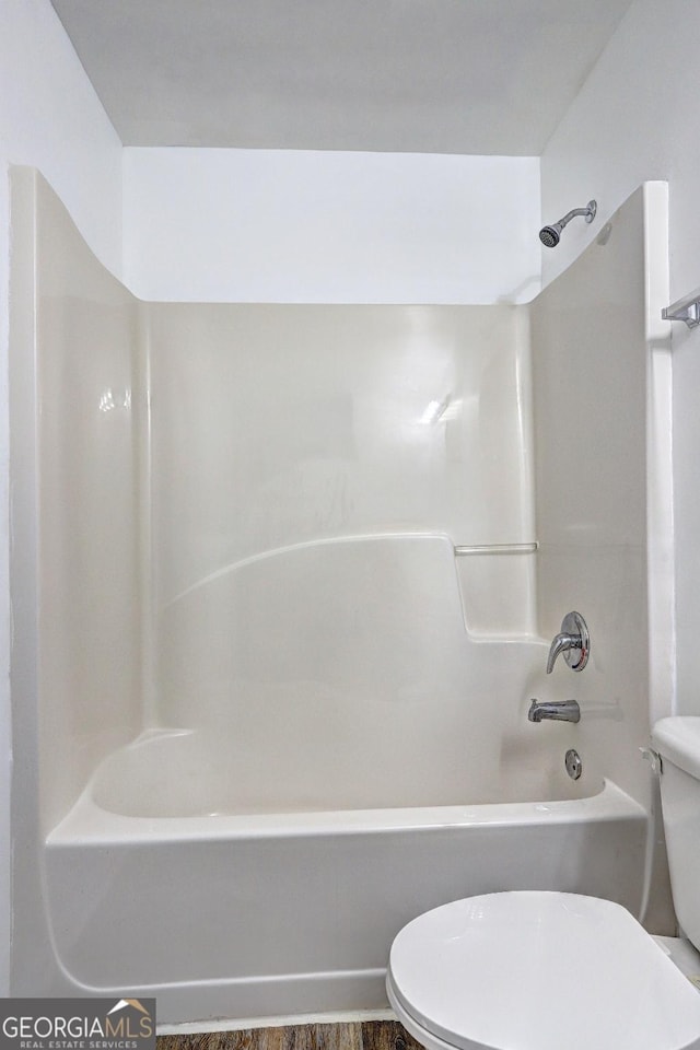 full bath featuring toilet and shower / washtub combination