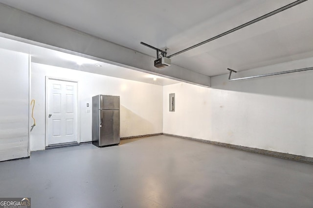 garage featuring freestanding refrigerator, a garage door opener, and electric panel